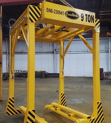 A 9-ton safety yellow below-the-hook lifting device designed, manufactured, and installed by CraneWerks, Inc. for a Columbus, Indiana company that makes diesel engines for commercial vehicles.