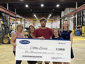 Collin Essex (with family) is presented with the Roger Graham Memorial Scholarship Fund by Charline Thomas (far left) and Ashley Larochelle (far right) in May 2020 at the CraneWerks manufacturing plant in Morristown, IN