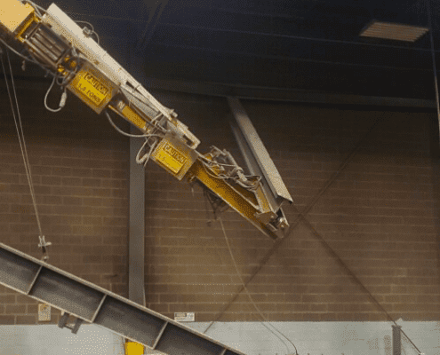 Catastrophic underhung overhead bridge crane runway fail, broken runway hanging loose from ceiling mount at metal finishing plant in central Indiana