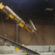 Catastrophic underhung overhead bridge crane runway fail, broken runway hanging loose from ceiling mount at metal finishing plant in central Indiana