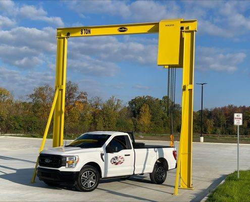 Outdoor monorail solution by CraneWerks for a national commercial truck dealer to undeck tractors in Detroit, Michigan