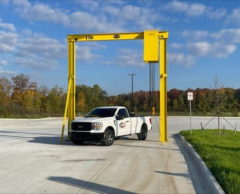 Outdoor monorail solution by CraneWerks for a national commercial truck dealer to undeck tractors in Detroit, Michigan