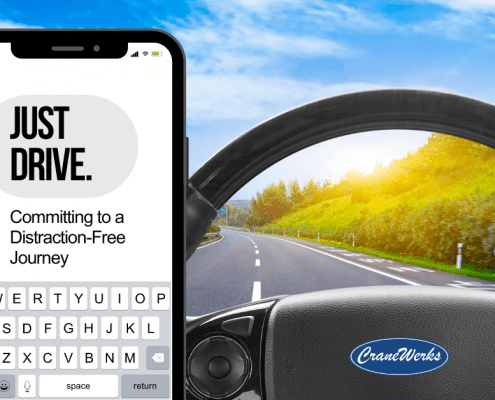 Open road with a cell phone that reads, "Just drive. Committing to a distraction-free journey."
