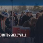 "The Bridge Unites Shelbyville: Walking for Hope" graphic over an image of Ashley Larochelle, Nicole Hornaday, Susan Allen, and other walkers are lining up for hot chocolate on the walking path at Shelbyville's first ever Coldest Night of the Year in 2025.