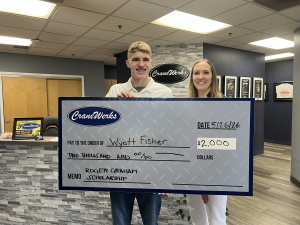 Wyatt Fisher being awarded the $2,000 Roger Graham Scholarship by President, Ashley Larochelle in May 2026.
