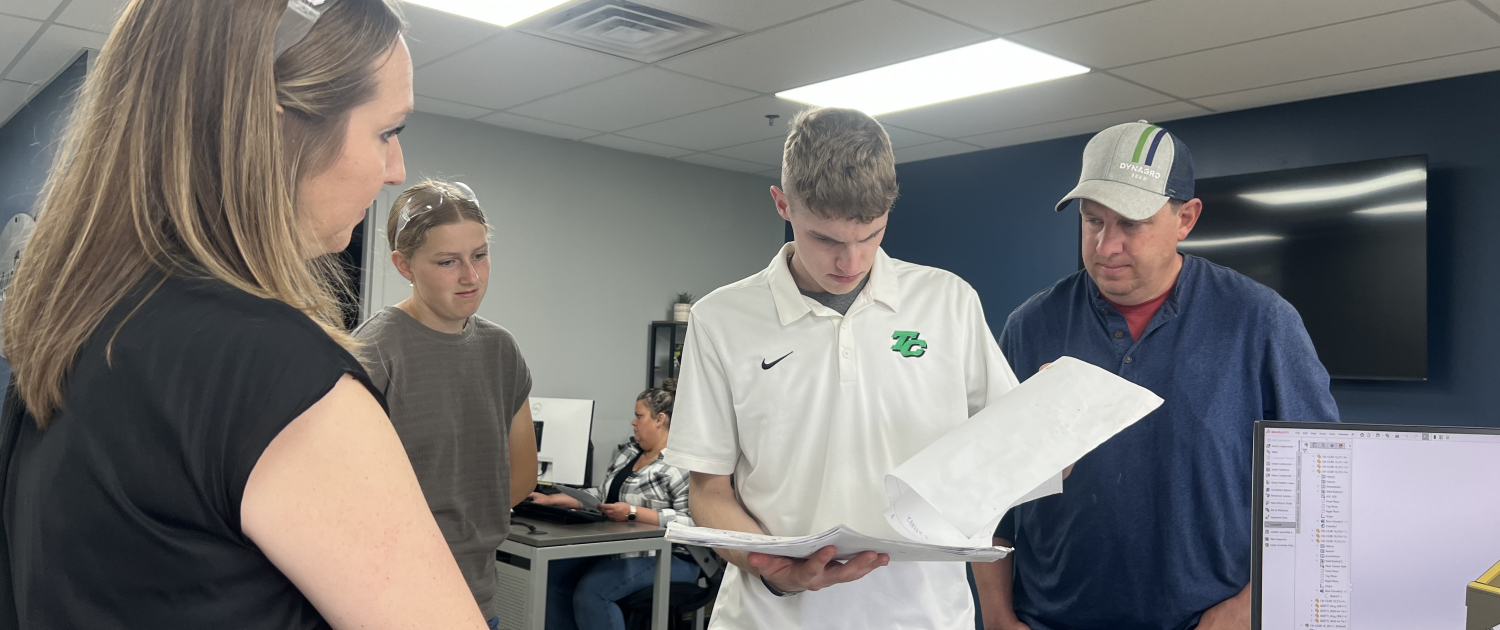 Wyatt Fisher views blue prints. 