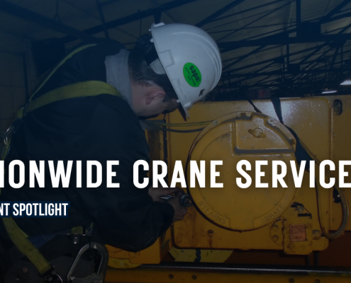 Nationwide Crane Service Department Spotlight Graphic from CraneWerks displays a man with a white hard hat performing service on an overhead bridge crane